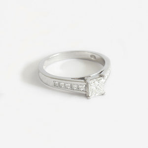 a platinum diamond ring with square shape centre and diamond shoulders