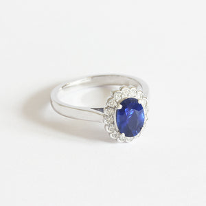 a beautiful oval sapphire and diamond set cluster ring in white gold