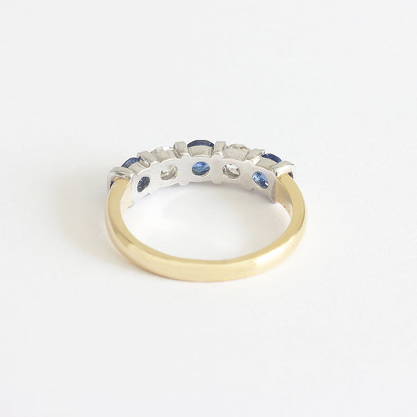 a contemporary gold sapphire diamond five stone ring with bar settings