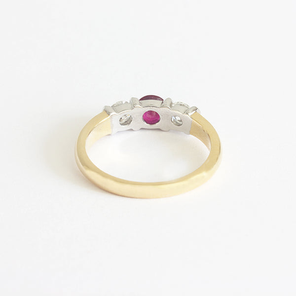 a ruby and diamond 3 stone ring in white and yellow gold with bar settings