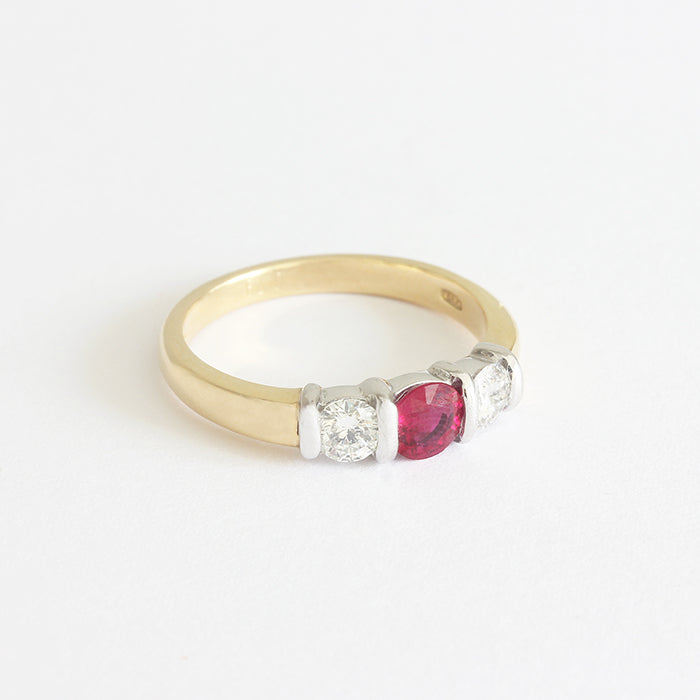 a ruby and diamond 3 stone ring in white and yellow gold