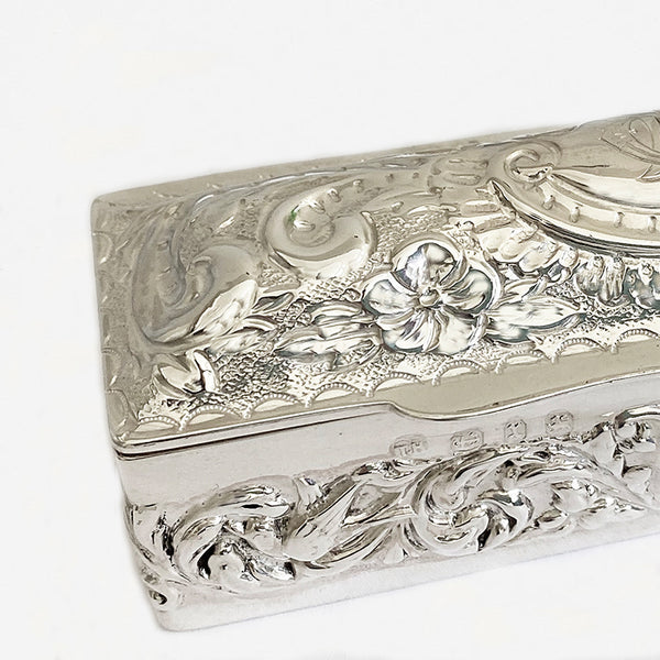 a victorian silver rectangular embossed box with initials and scroll floral design 1897