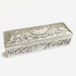 a victorian silver rectangular embossed box with initials and scroll floral design 1897