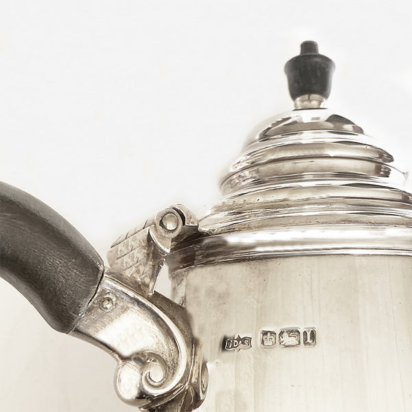 a vintage antique silver coffee pot with wooden handle