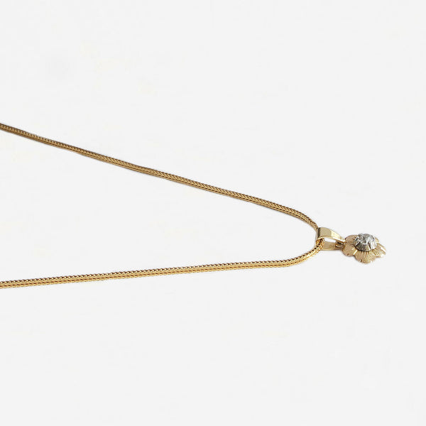 a secondhand floral design pendant with a central claw set diamond and gold chain