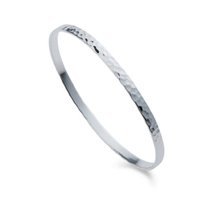 a silver flat hammered design bangle by christin ranger