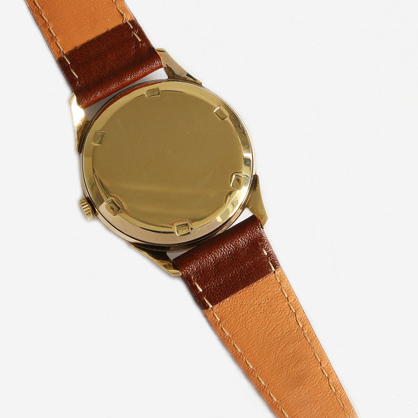 a preowned vintage garrard watch with gold case 