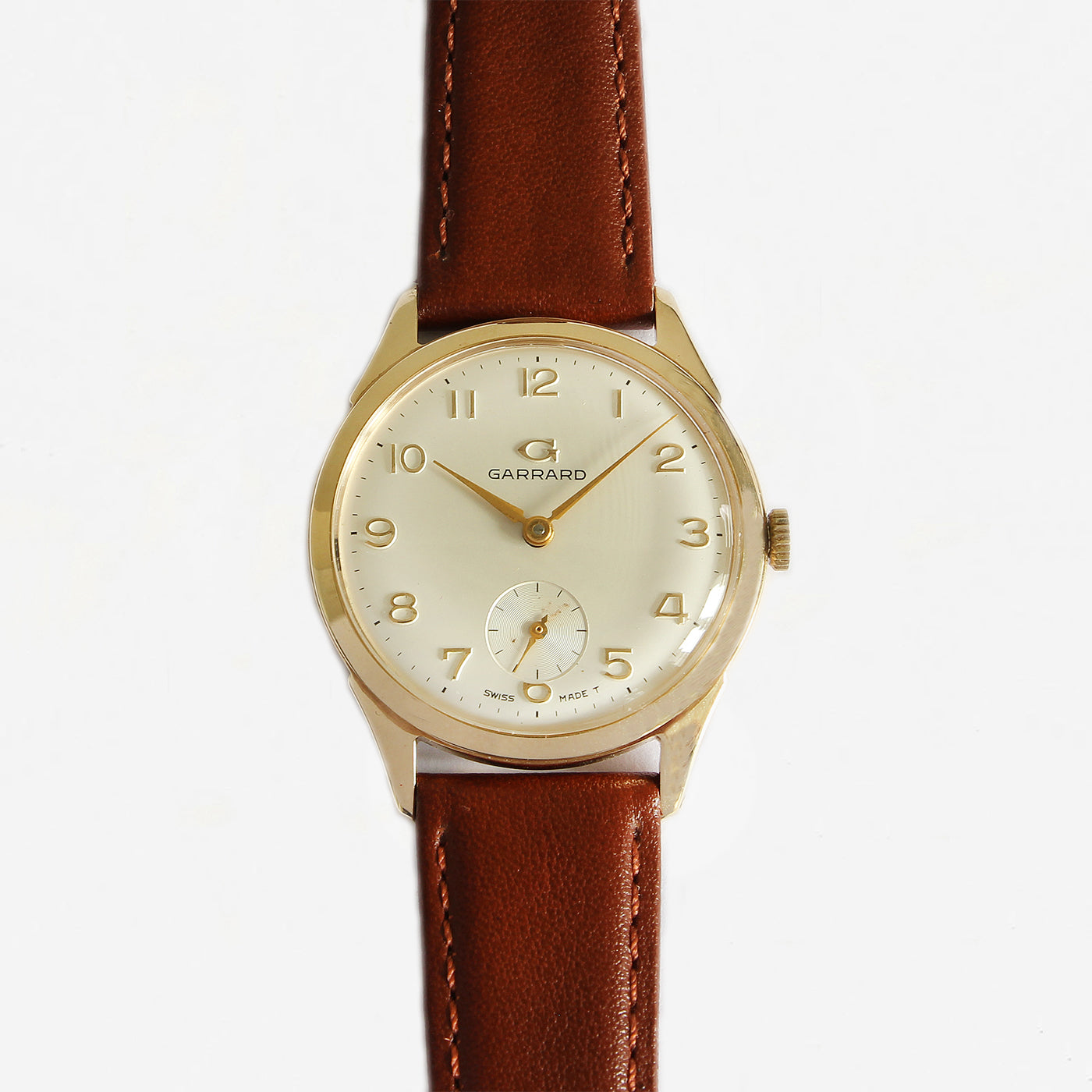 a garrard secondhand vintage watch with gold case and leather strap