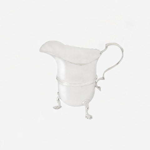 a silver jug for cream dated London 1928