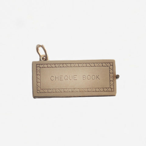 a yellow gold vintage cheque book charm with cheque inside secondhand