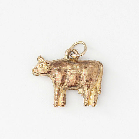 a vintage yellow gold cow charm with full hallmark