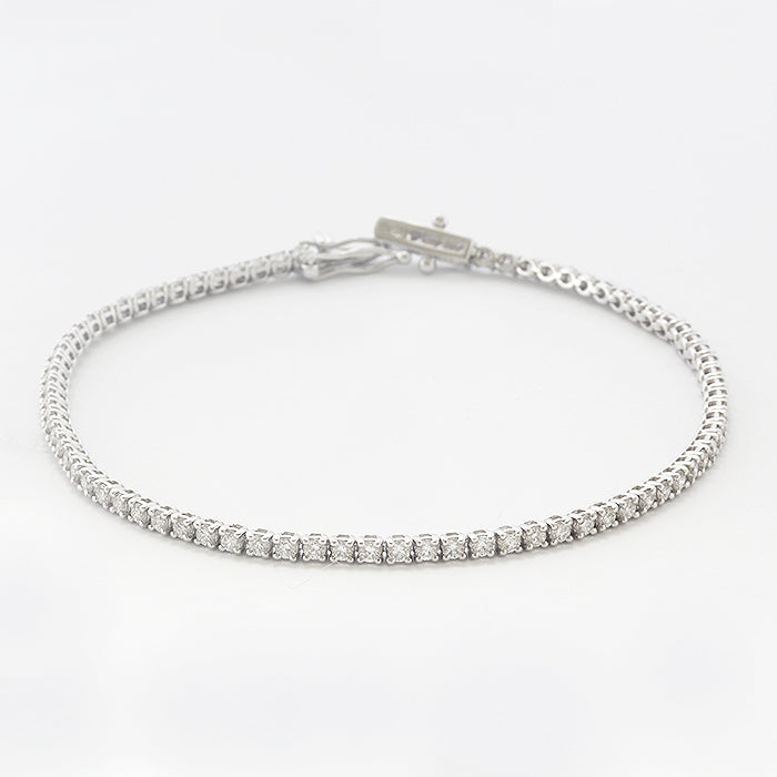 a diamond set tennis bracelet in white gold