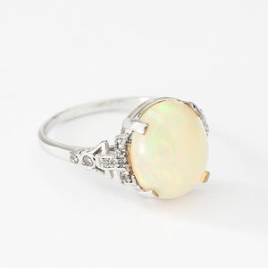 oval opal and diamond claw set ring set in 18ct white gold