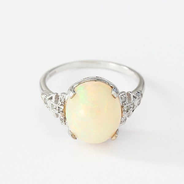 white gold opal and diamond ring with a claw setting and diamond shoulders 