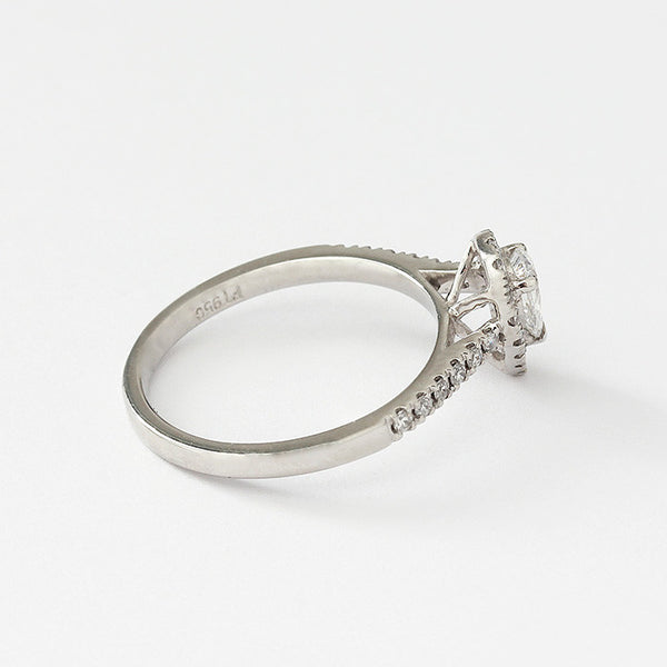 a diamond cluster ring in platinum with diamond shoulders all claw set