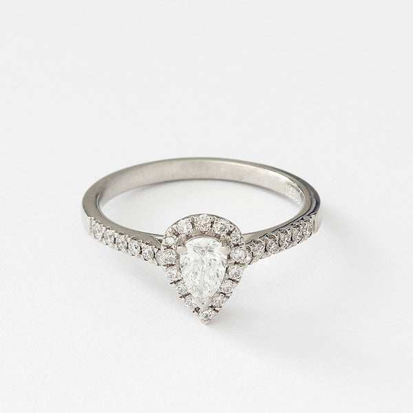 a diamond set cluster ring with a central pear shaped stone and small diamonds around head and shoulders