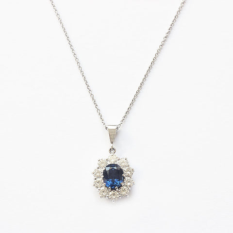 a sapphire diamond oval cluster pendant with trace chain all in white gold