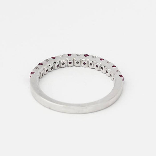 an elegant ruby and diamond half eternity ring in white gold with 8 rubies and 7 diamonds