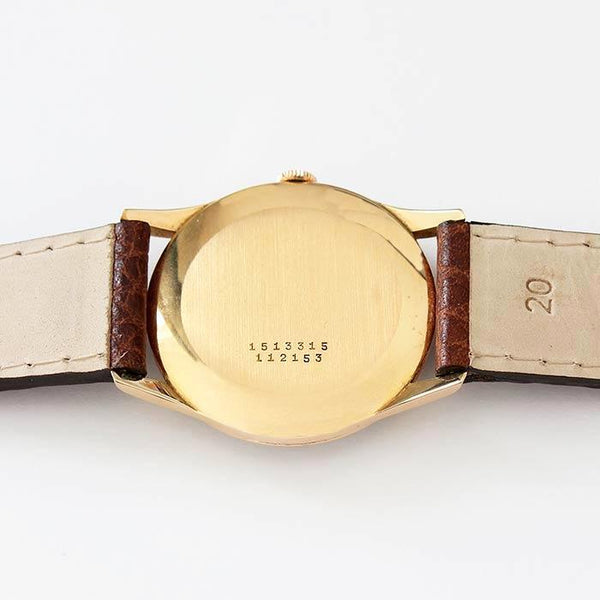 a secondhand preowned universal gents watch with 18ct rose gold case and brown leather strap with 33mm dial